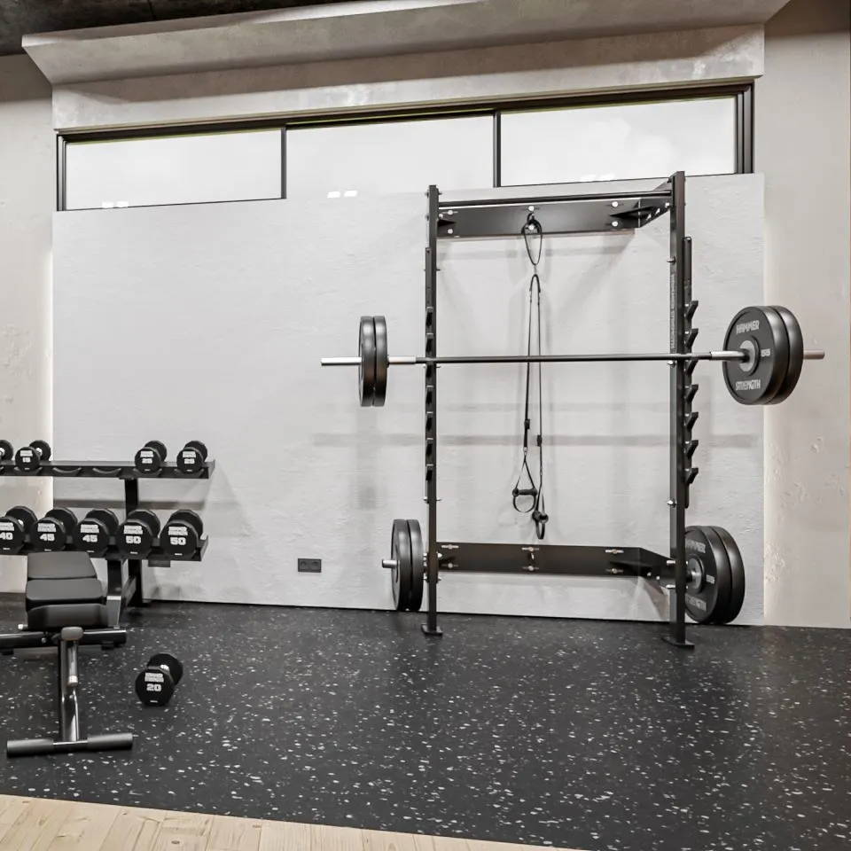Home gym with Home Squat Rack bolted to the wall and other Hammer Strength  equipment